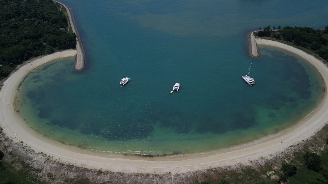 three boats floating on top of a body of water