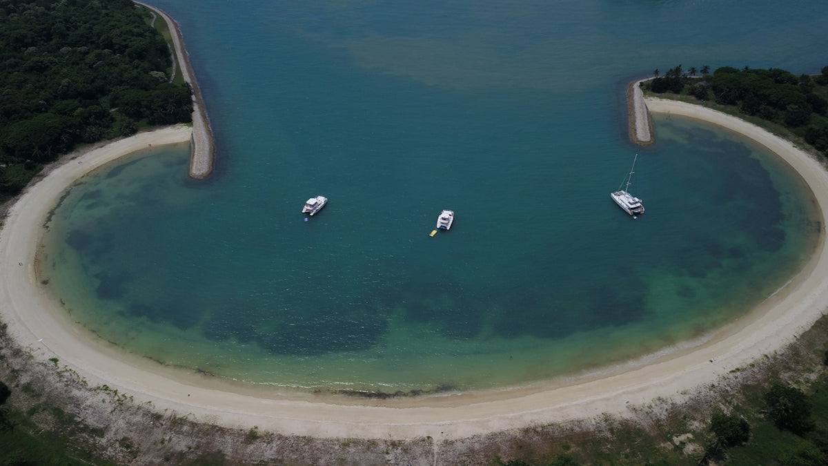 three boats floating on top of a body of water
