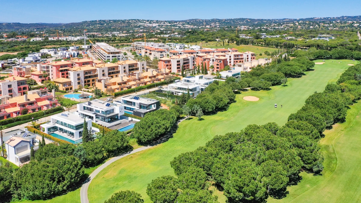 an aerial view of a golf course and buildings