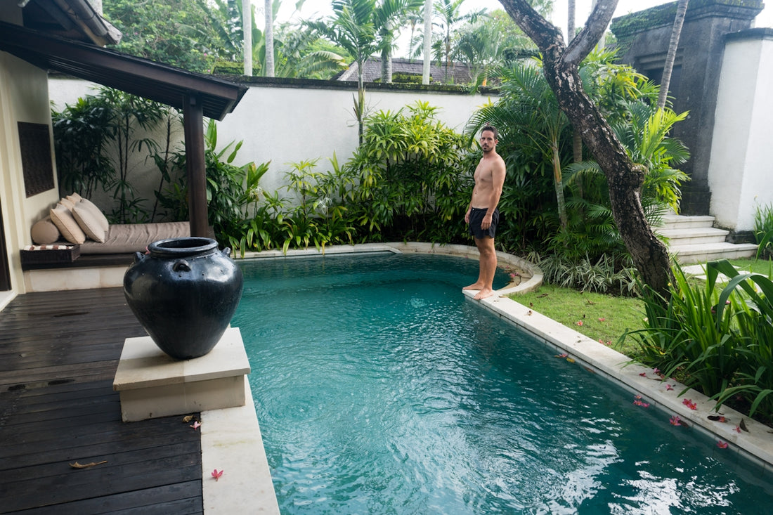 A man standing next to a swimming pool