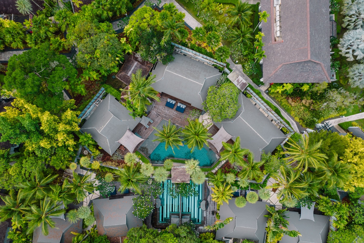 An aerial view of a house surrounded by trees