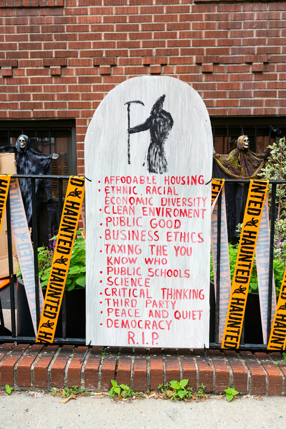 Tombstone lists concepts like affordable housing and democracy.